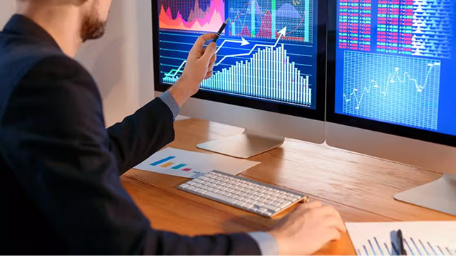 Person analyzing trading charts
